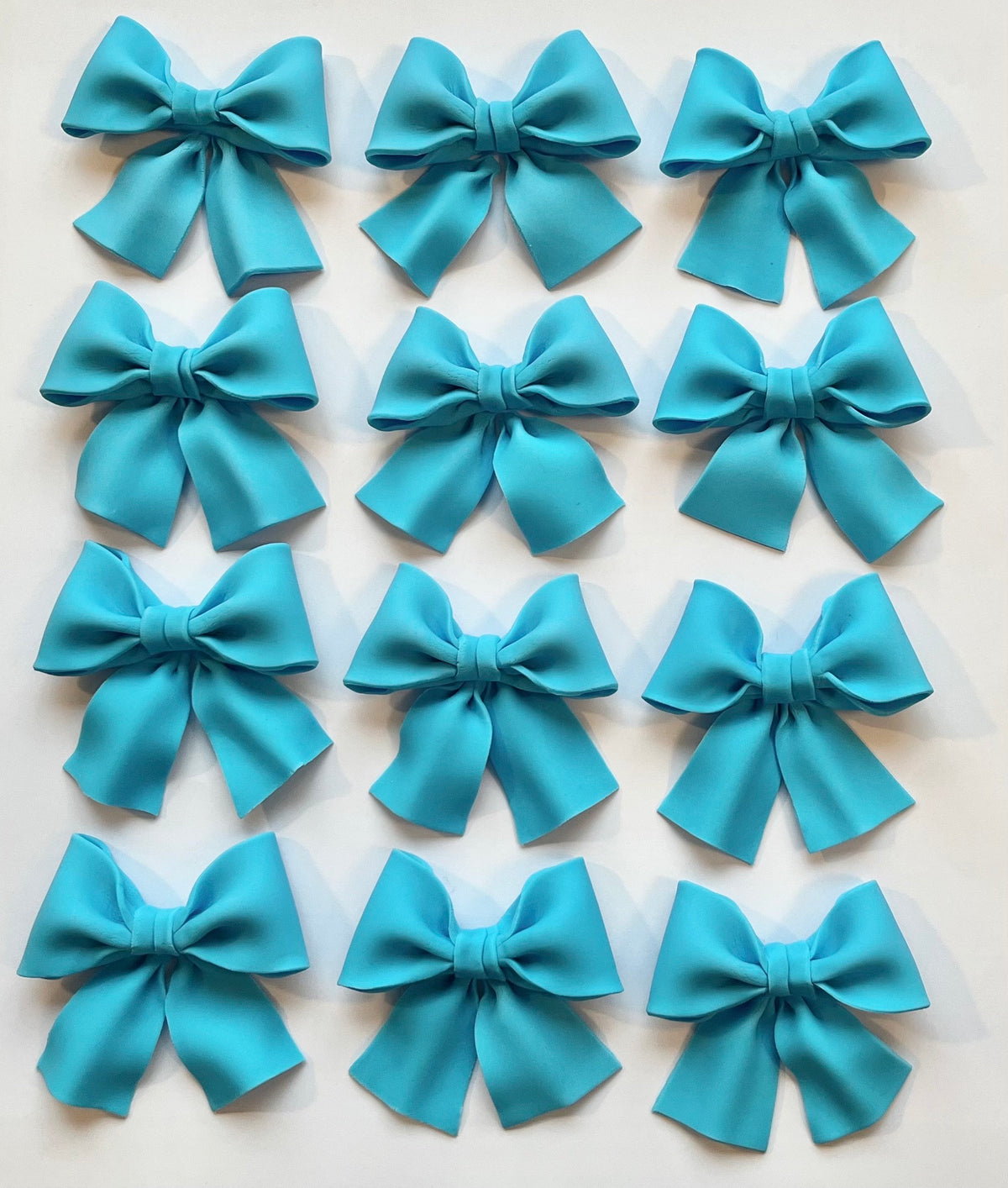 Set of 12 blue bows cupcake toppers.