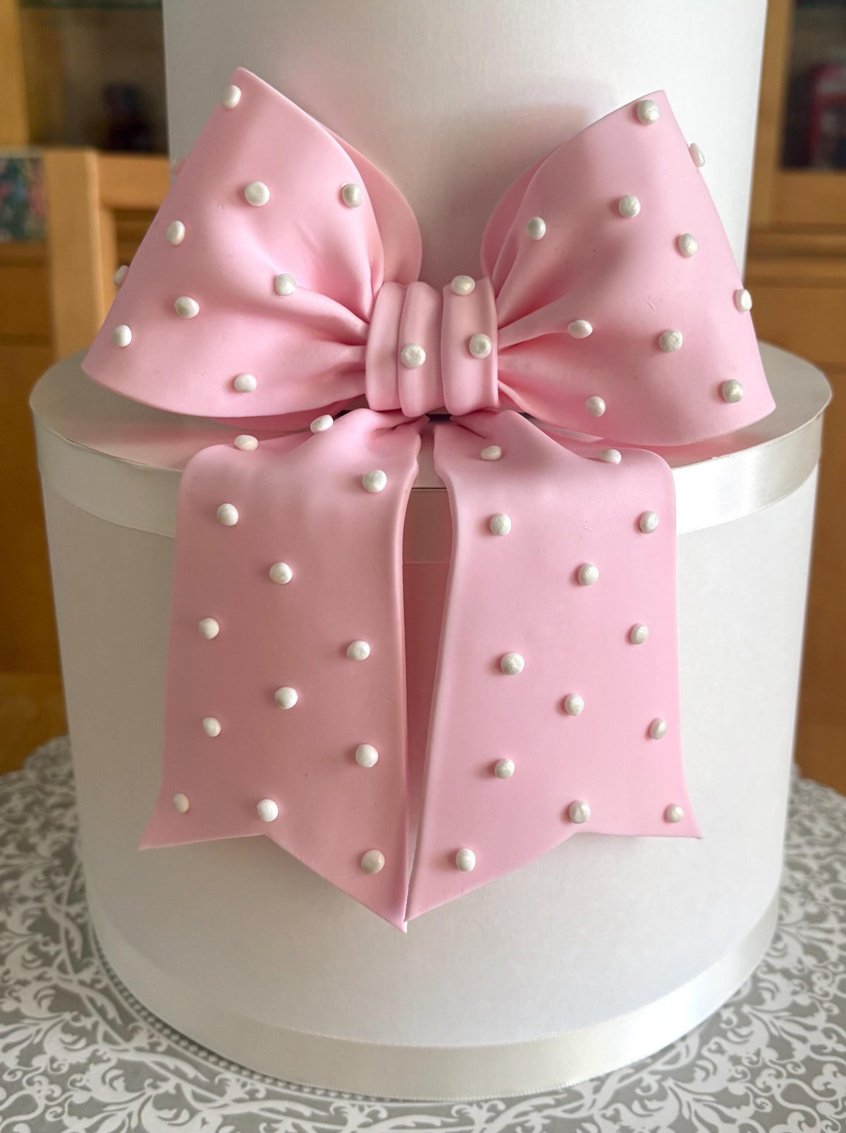 Big light pink fondant bow with pearl dots