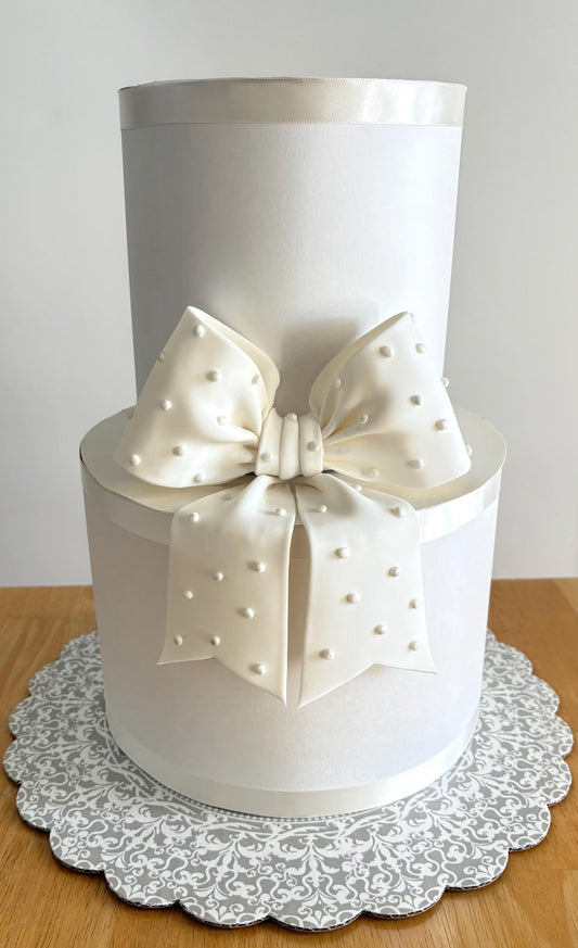 Big white fondant bow with pearl dots