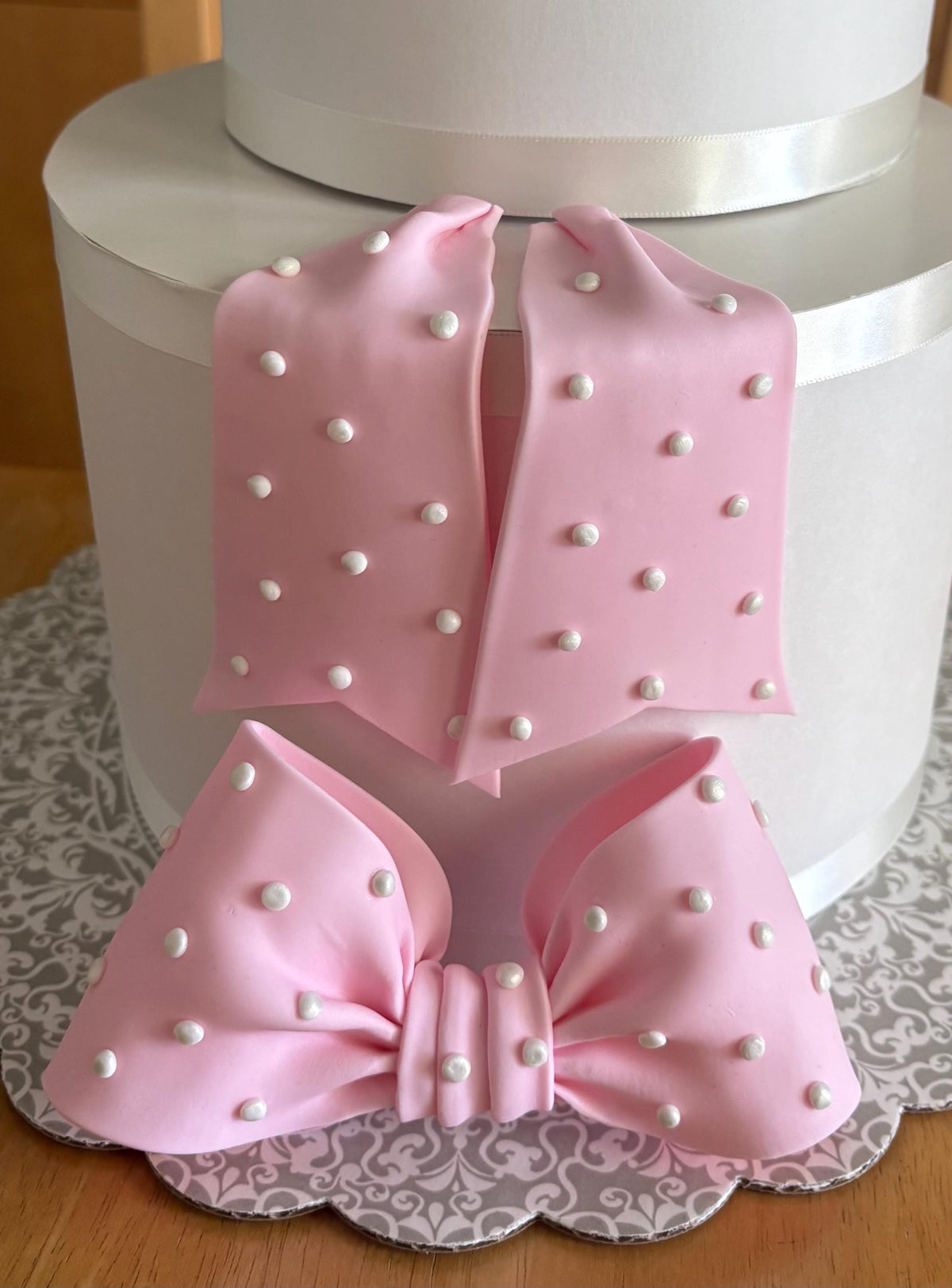Big light pink fondant bow with pearl dots