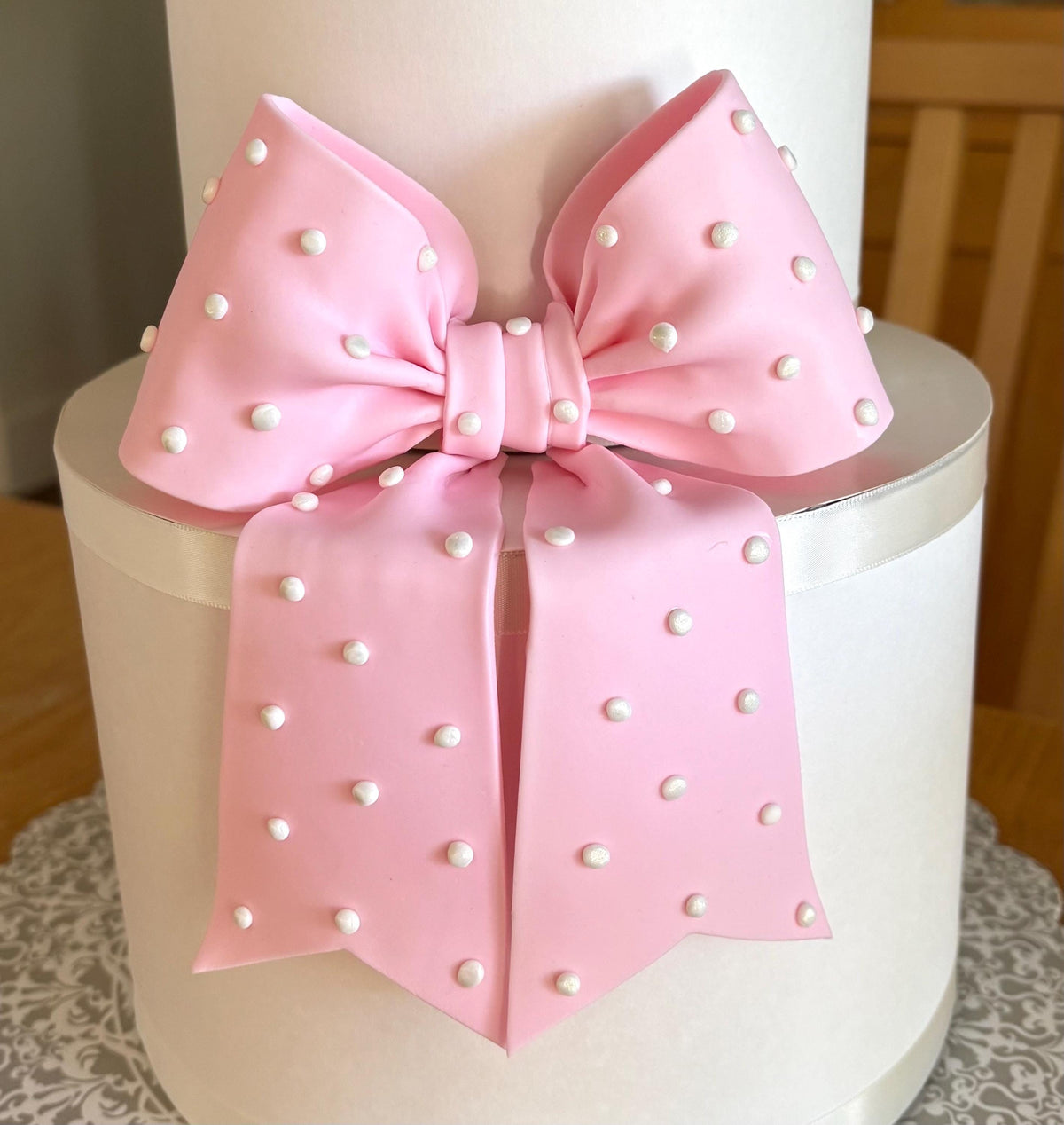 Big light pink fondant bow with pearl dots