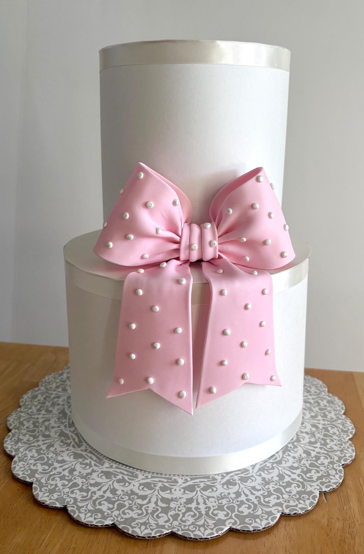 Big light pink fondant bow with pearl dots