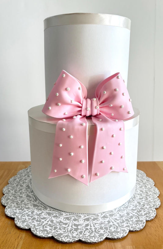 Big light pink fondant bow with pearl dots
