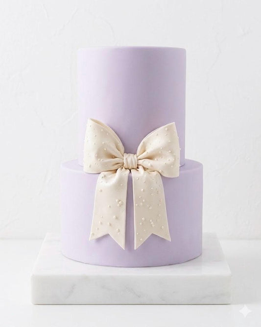 Big white fondant bow with pearl dots