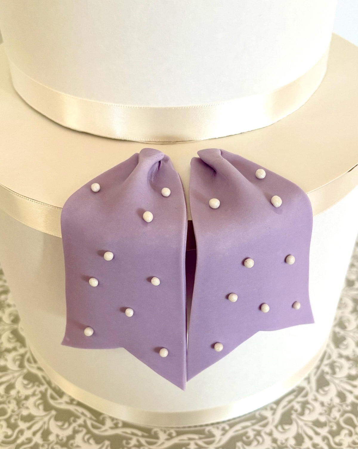 Big lavender fondant bow with pearl dots